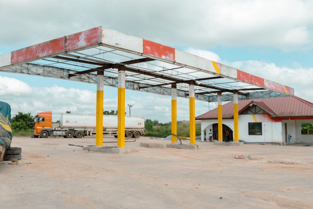 Camión cisterna estacionado junto a una estación de servicio vacía