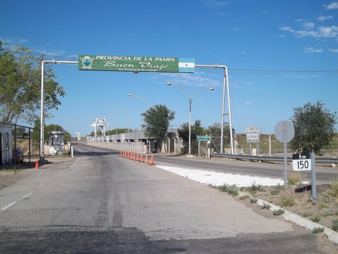 Río Negro fija el 29-oct para tomar las rutas 22 y 151 Calzada sobre el dique Punto Unido, en el límite entre Río Negro y La Pampa, con conos naranjas y el cartel de bienvenida a La Pampa